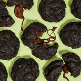 Vegan Raspberry Dark Choc New York Cookie with melted dark chocolate and raspberry pieces on green background by Crumbs & Doilies